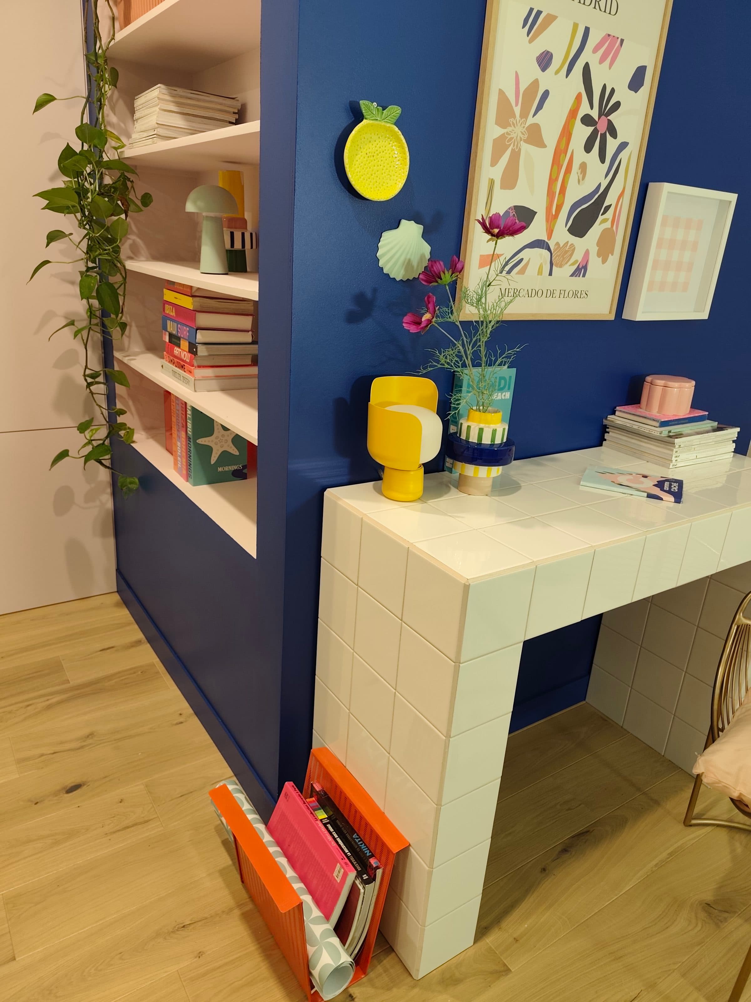 Niche bleue avec étagères décorées et bureau carrelé